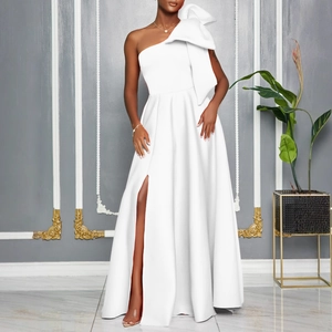 Detail of elegant white one-shoulder evening gown with large decorative bow and high slit
