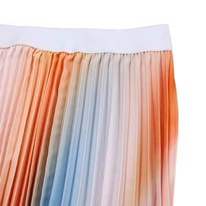 Close-up of pleated chiffon skirt featuring colorful gradient and elastic waistband