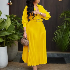 Detail of elegant yellow pleated dress with V-neckline, long sleeves and belted waistline