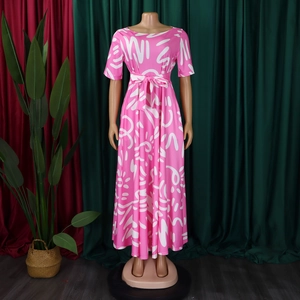 Detailed view of pink long dress with white abstract prints and high-waist bow tie