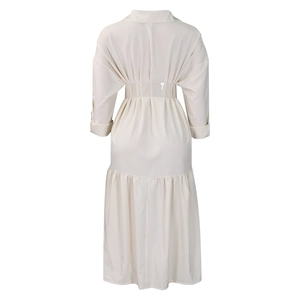 Detail view of the elastic high waist and tiered ruffle hem on the back of this beige dress