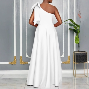Detailed back view of a white one-shoulder evening gown with a large decorative bow