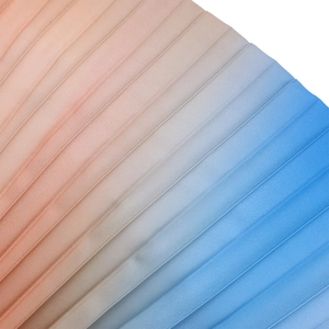 Detailed view of the gradient pleated chiffon fabric transitioning from pink to blue