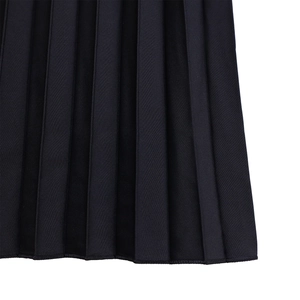 Close-up of pleated black fabric showing fine texture and hem stitching on evening dress