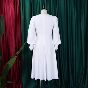 Detail view of white long-sleeve dress back with invisible zipper and A-line skirt
