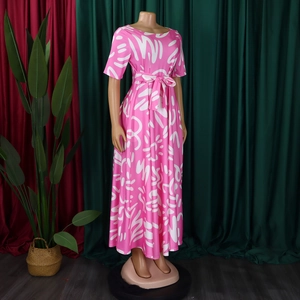 Close-up of the adjustable waist tie and abstract white pattern on a pink dress