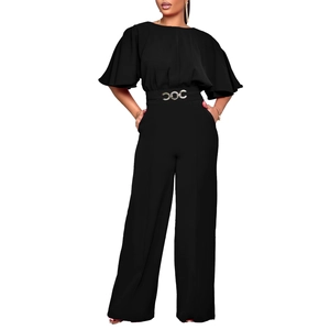 Detail of elegant black jumpsuit featuring a ruffled sleeve and silver chain belt buckle