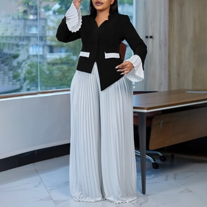 Detail of flared cuffs and pleated texture on professional black and white two-piece set