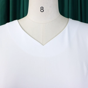 Detail view of the V-neck design on this elegant white solid color A-line dress
