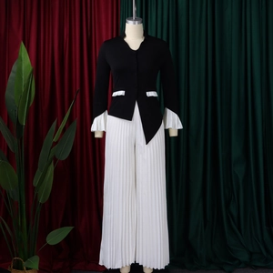 Detail of high-waisted pleated wide-leg pants and ruffled bell sleeve cardigan set
