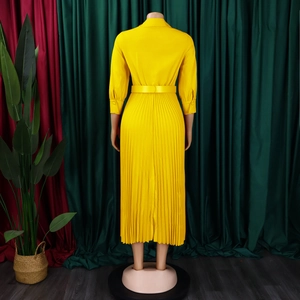 Back view of yellow long sleeve midi dress with elegant accordion pleats and waist belt