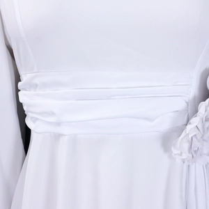 Detail of elegant white dress with ruched waist design and 3D floral accent
