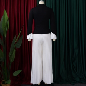 Detail view of the back of a two-piece set with flare sleeves and pleated wide-leg pants