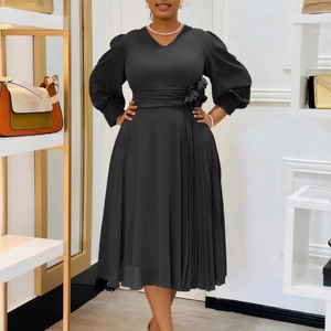 Detail of elegant black V-neck dress with long puff sleeves and 3D flower waist ornament