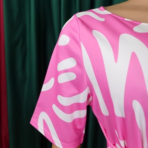 Detail of pink and white abstract print dress showing silky texture and quality stitching