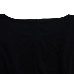 Detail shot of invisible back zipper closure on high waist black wide leg jumpsuit