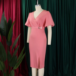 Detailed view of a V-neck coral dress with puff sleeves and belted waist on a mannequin