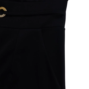 Close-up of black jumpsuit waist with gold rhinestone ring belt detail and smooth fabric