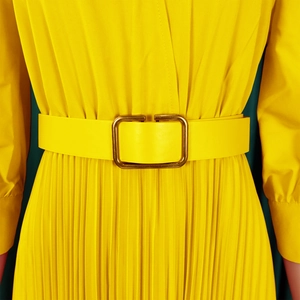 Close-up of pleated dress waist with matching wide belt and golden rectangular buckle