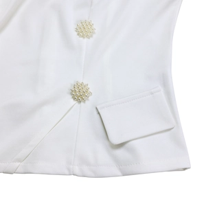 Detail of elegant white fabric texture with pearl cluster buttons and stitching