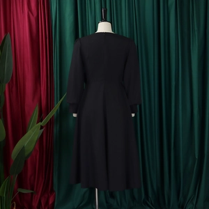 Rear view of the elegant black long sleeve A-line dress showing the zipper closure
