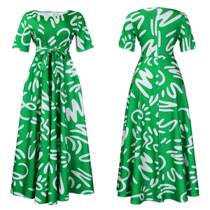 Detailed view of emerald green maxi dress with white abstract prints and belted waist