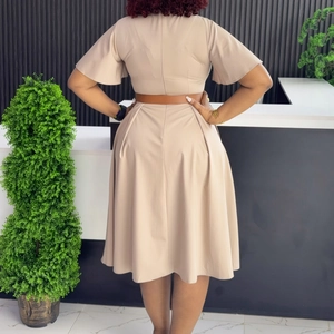 Rear view of beige A-line dress featuring ruffle sleeves and a brown leather waist belt