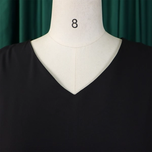 Detail shot of elegant black V-neckline featuring high-density woven fabric texture