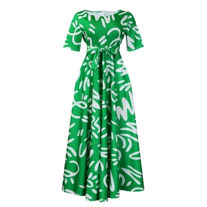 Detail of green summer dress with white pop art print and waist tie belt