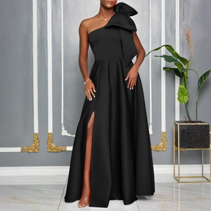 Detailed view of the elegant one-shoulder black dress with a large bow and high leg slit