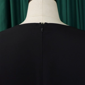 Close-up of the back detail on this solid black dress showing a hidden zipper closure