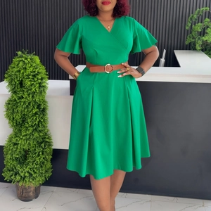 Detail of a bright green V-neck wrap dress with ruffle sleeves and a brown waist belt