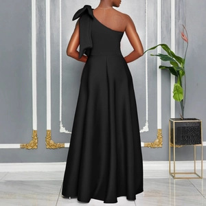 Detailed back view of a black one-shoulder satin dress with a large oversized bow detail