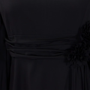 Detail of elegant black dress showing wide pleated waist and 3D fabric flower accent