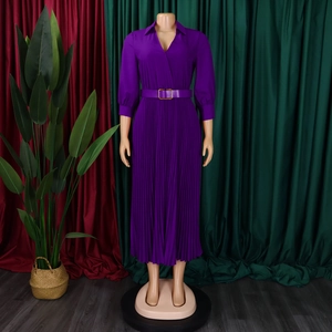 Detail of deep purple pleated maxi dress with V-neckline and matching gold buckle belt