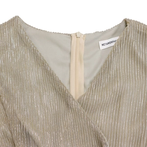 Detail of champagne gold pleated V-neck dress with a hidden back zipper closure