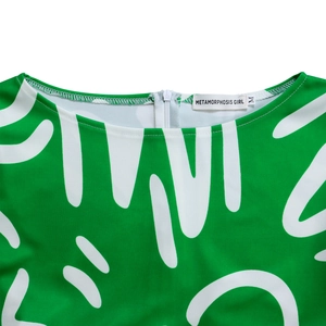 Macro view of neck detail with gray invisible zipper on green abstract print dress