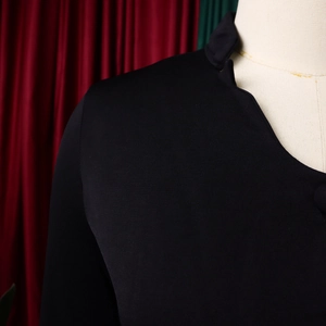Detailed view of the black flare sleeve top with a V-neckline on a white mannequin