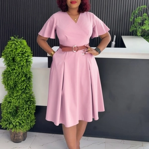 Detail of pink wrap dress featuring V-neckline, ruffle sleeves and brown leather belt