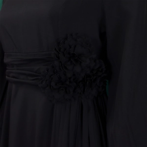 Detail of elegant black dress showing ruched waist design and 3D chiffon floral appliqués