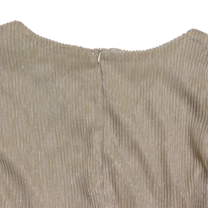 Detailed macro view of champagne gold pleated fabric with a hidden zipper closure
