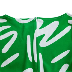 Detail view of the invisible zipper and white stitching on green African print dress