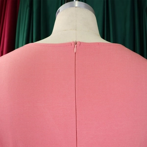 Detail of pink ribbed fabric texture with invisible back zipper on a stylish dress