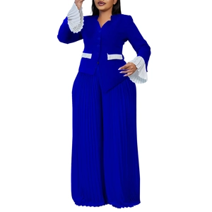 Detail of flared cuffs with white pleated trim on a dark blue button-down shirt