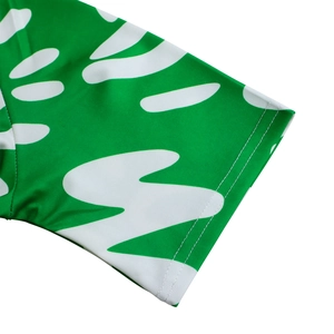 Close-up of sleeve cuff detail with green African leaf print and double-needle stitching
