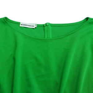 Detail view of round neckline with invisible zipper on bright green jumpsuit fabric