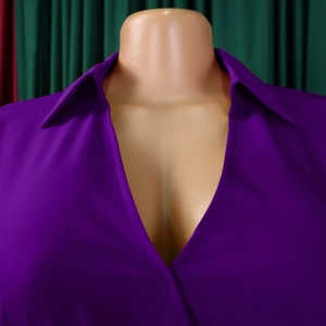 Detail of elegant deep V-neckline and pointed collar on a purple long sleeve dress