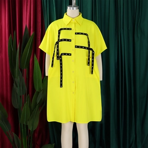 Detail of yellow short sleeve shirt dress featuring industrial metal eyelet webbing