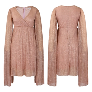 Detail view showing rose gold pleated metallic fabric with a deep V-neckline and cape sleeves