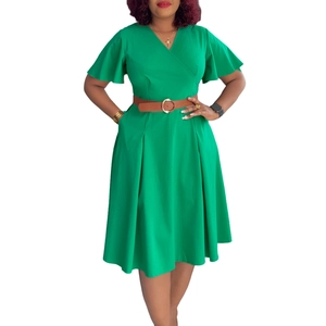 Detail of emerald green V-neck dress with ruffle sleeves and brown buckled waist belt